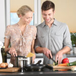 woman and man cooking together at home