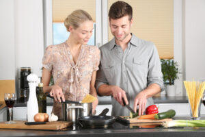 woman and man cooking together at home