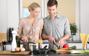 woman and man cooking together at home